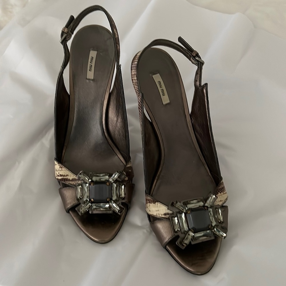 Mui Mui jeweled snakeskin open toe pumps.